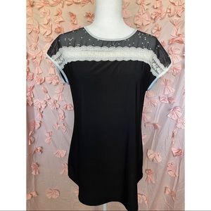 Black and white sheer lace top with bow on back.